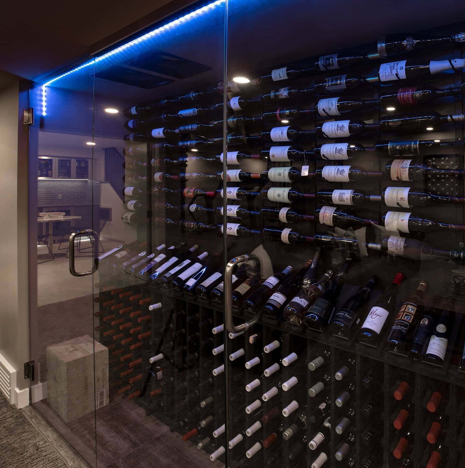 Glass-walled wine room with blue LED lighting by Kay2 Contracting, Mayland Heights, Calgary