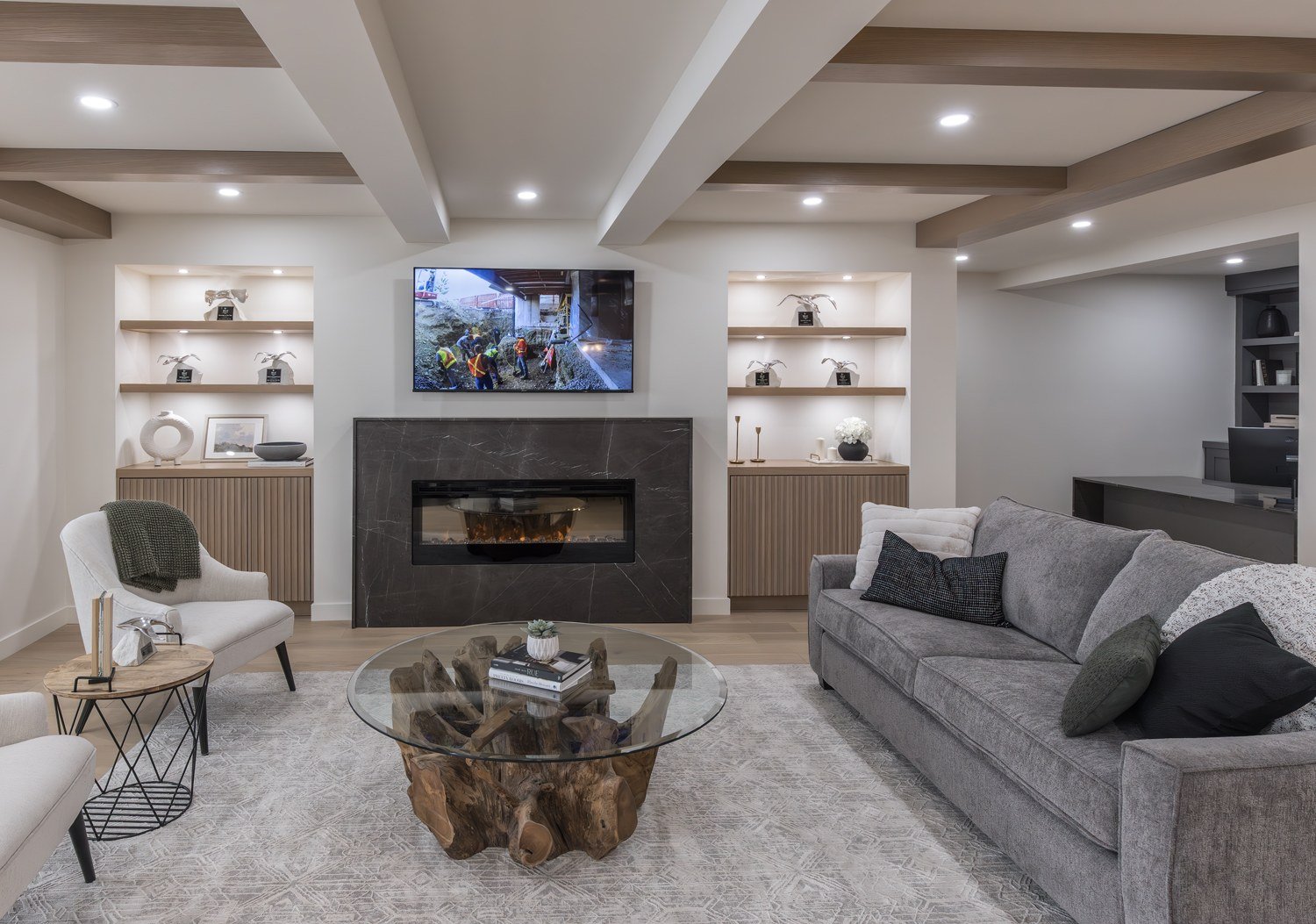 Lounge with fireplace and custom shelving at the Kay2 Showroom