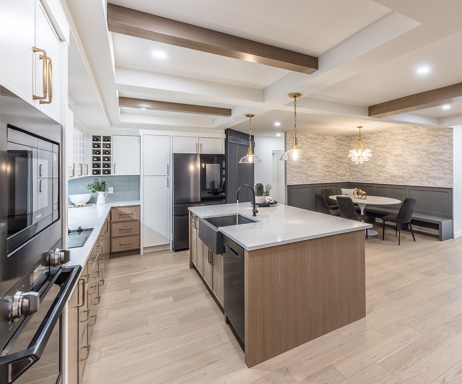 Display kitchen with wood-grain island and white cabinetry at the Kay2 Showroom